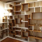 Bibliothèque sur mesure haut de gamme avec intégration de branches de bois brut et casiers blancs asymétriques à Angers.