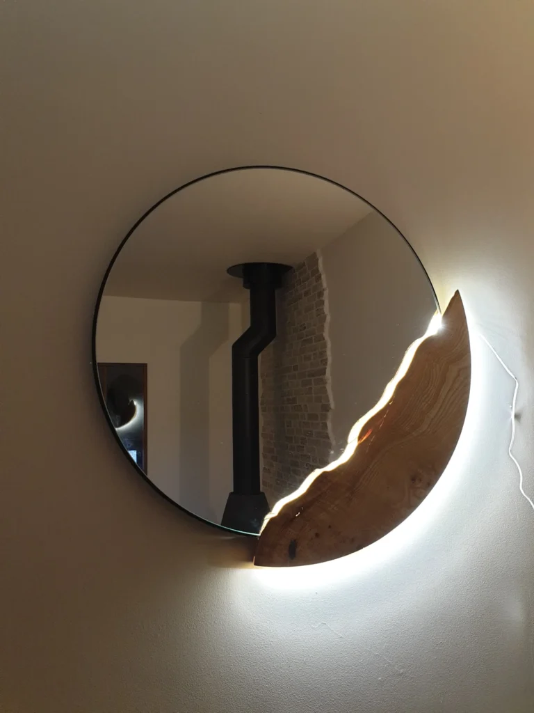 Miroir rond rétroéclairé avec bordure organique en bois massif sculpté, création artisanale Garcia Rénovation Angers.